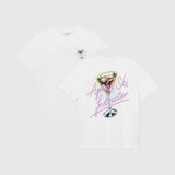 Two white short-sleeve T-shirts shown on a light gray background, displaying the front and back. The front features a small pink graphic on the left chest, while the back displays a larger graphic of a martini glass with the text 'Agnes Ski Instructor' in pink script.