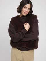 Black coffee faux-fur vest for women by MAZINE, shown on a model, highlighting soft texture and stylish fit.