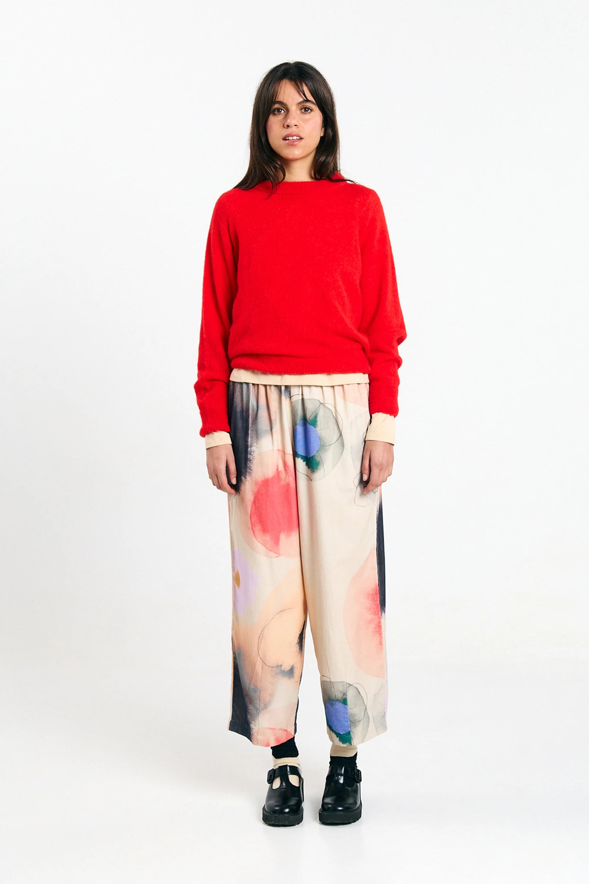 Red Babol Jumper sweater by SUITE13LAB, shown laid flat with long sleeves and ribbed cuffs, close-up of knit fabric.