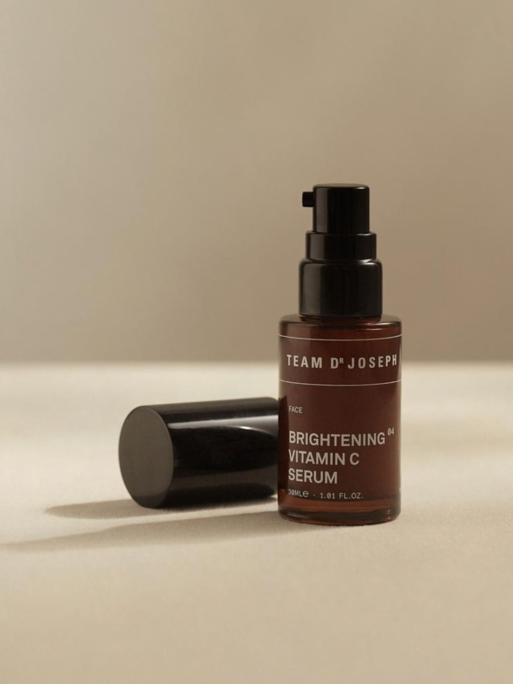Brightening Vitamin C Serum by TEAM DR JOSEPH in a 30ml bottle, showcasing the clear serum inside a sleek container.