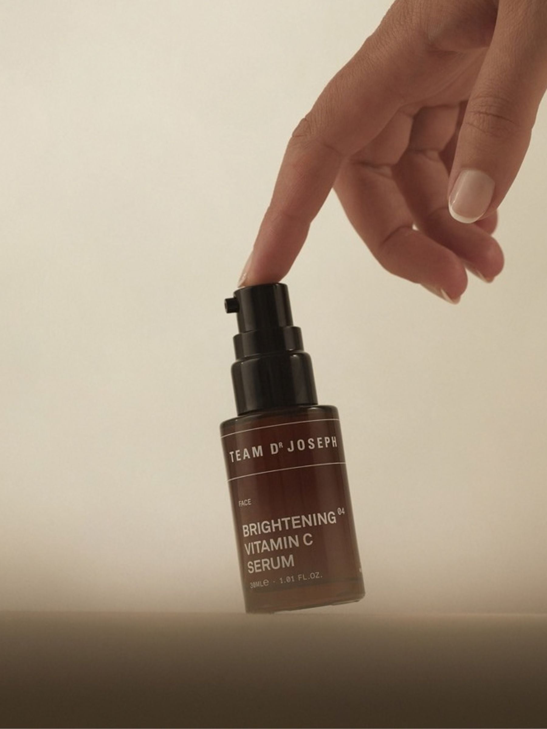 Brightening Vitamin C Serum by TEAM DR JOSEPH in a 30ml bottle, showcasing the clear, amber-colored serum in a sleek dropper bottle.
