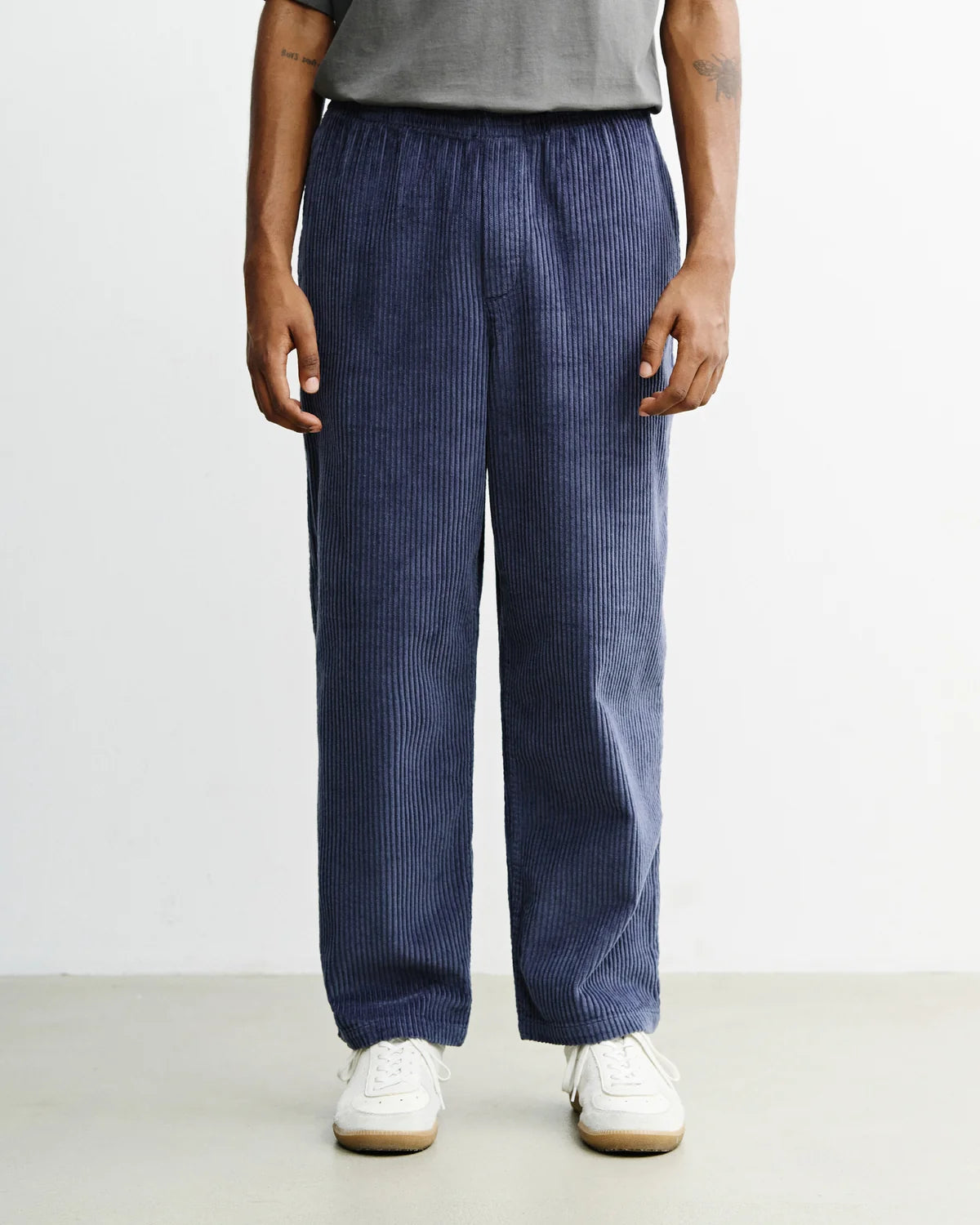 Men's wide-leg ash blue corduroy trousers by ROTHOLZ, featuring organic cotton fabric and relaxed fit for casual style.