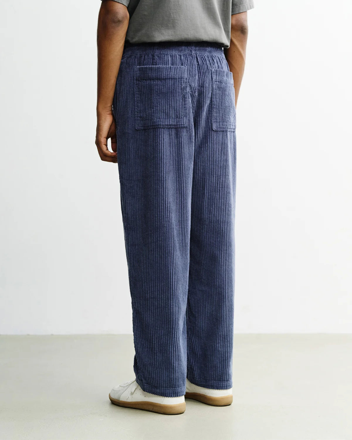 Men's wide-leg corduroy trousers in ash blue by ROTHOLZ, made from organic cotton, featuring a relaxed fit and textured fabric.