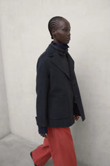 Dana women's charcoal khaki jacket by ECOALF, shown in a stylish outdoor setting with a close-up of the jacket's fabric and design.