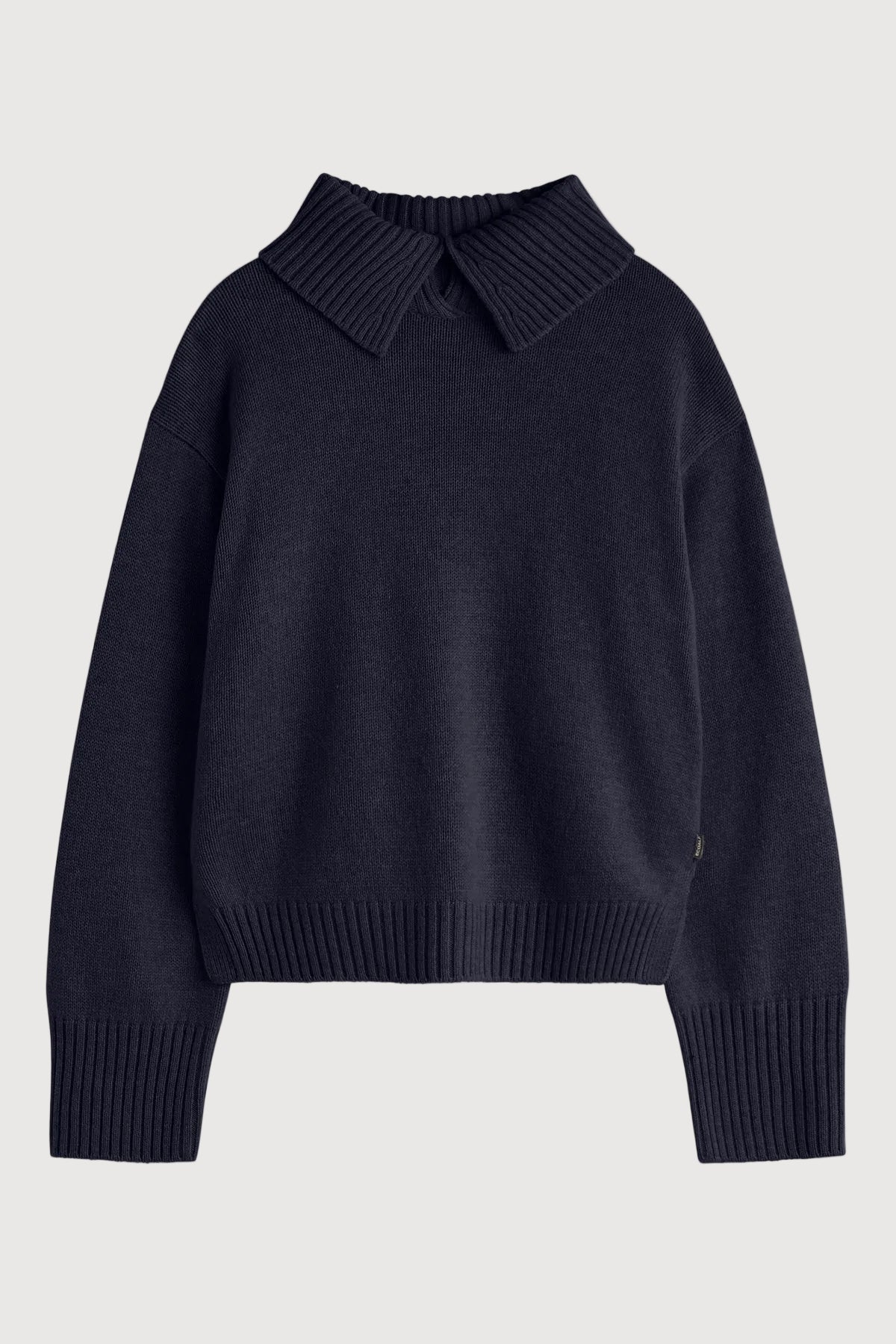 Black sweater with a collar on a light gray background