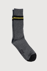 Gray sock with a yellow and black striped pattern on a white background
