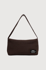 Brown textured handbag with a visible brand label on a light gray background